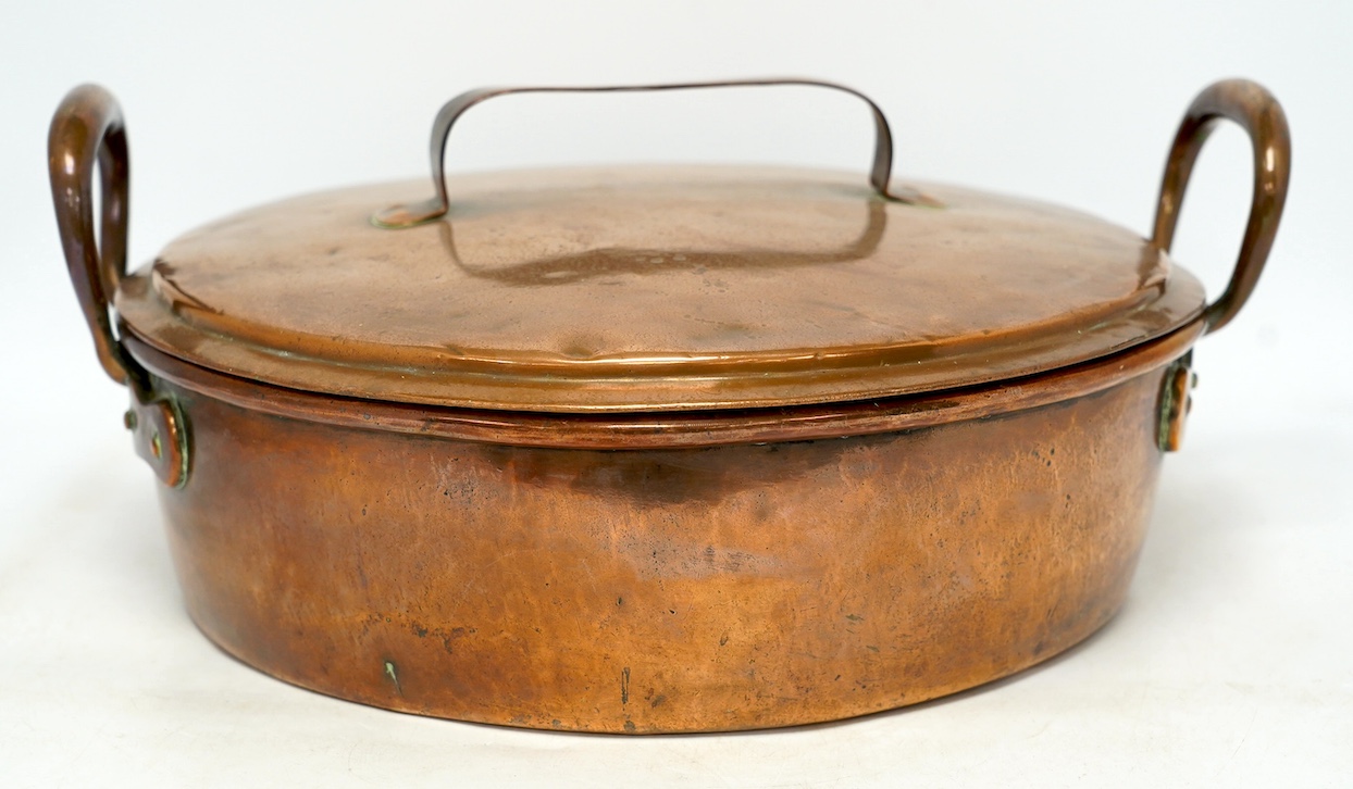 Two copper pans, one handled and the other with cover, 38cm diameter. Condition - fair